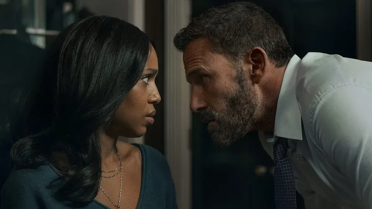 A bearded man in a shirt and tie leans in close to a woman in a dark room, in a still from Netflix’s Animals
